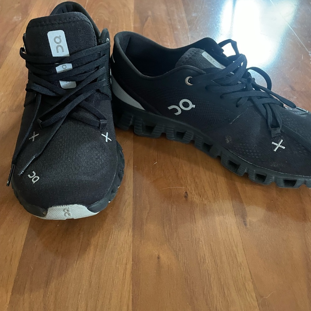On Running Black Athletic Shoes with Breathable Mesh and Distinctive Sole